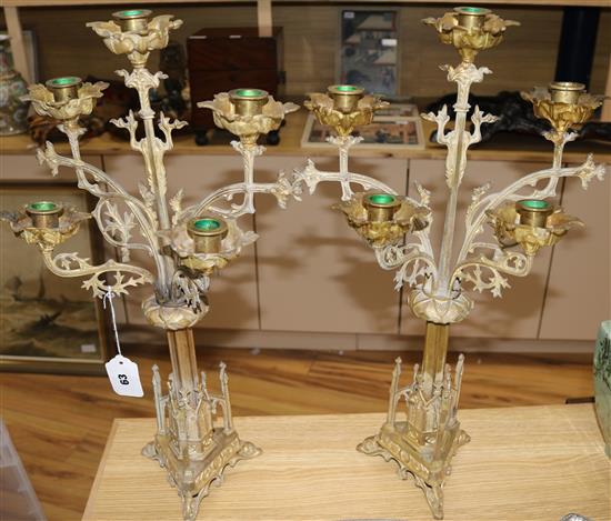 A pair of French gilt metal gothic style candelabra, 22in.